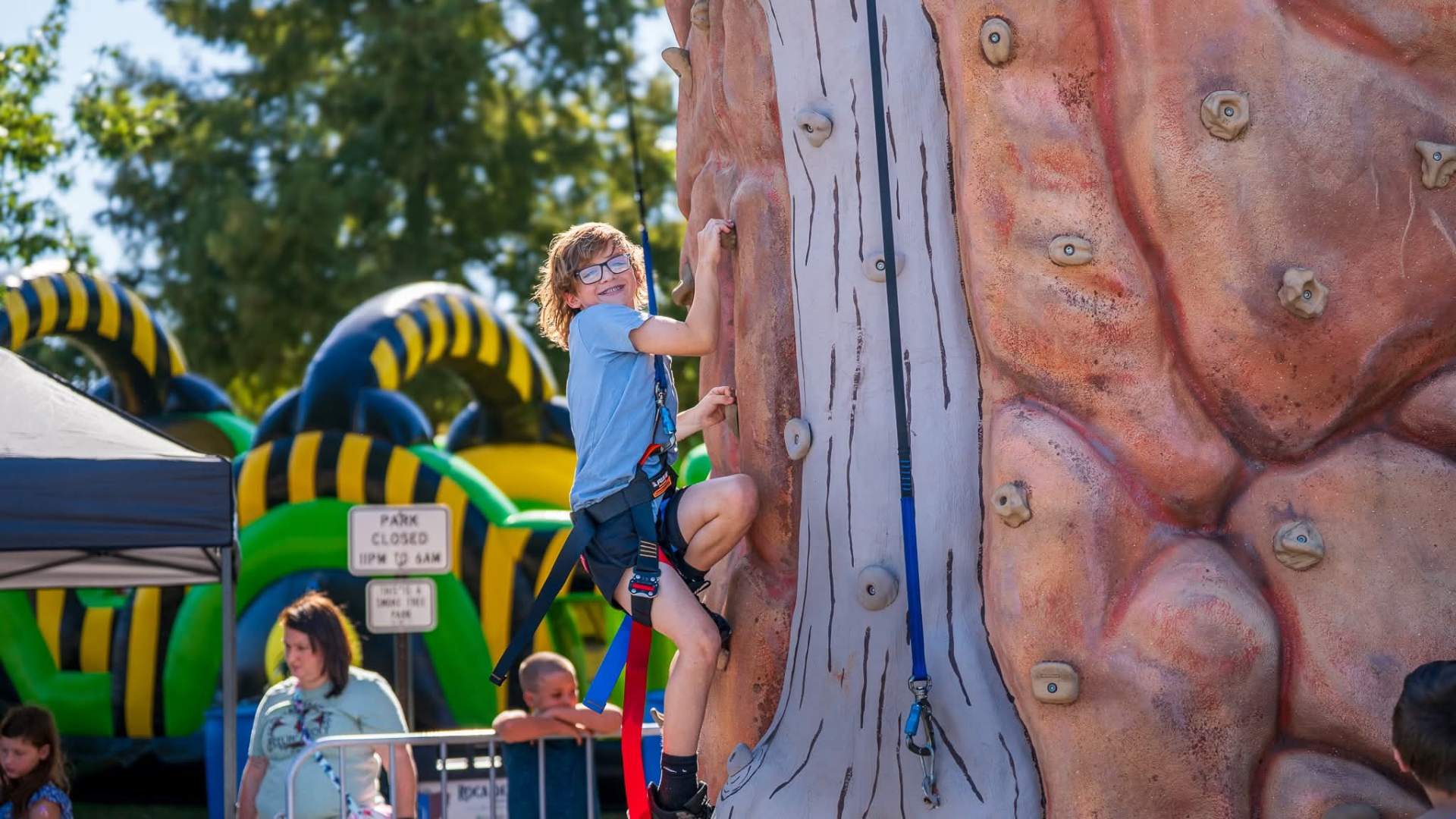 Kid climbing rock wall at Fort Smith party event