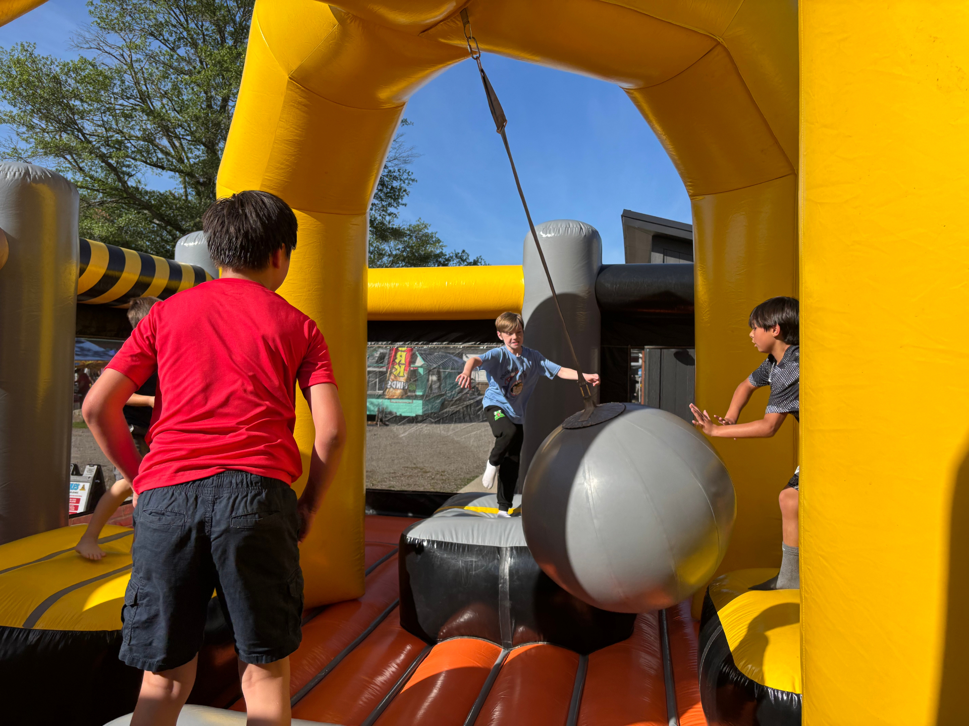 Kids playing wrecking ball bouncer game in Rogers Arkansas