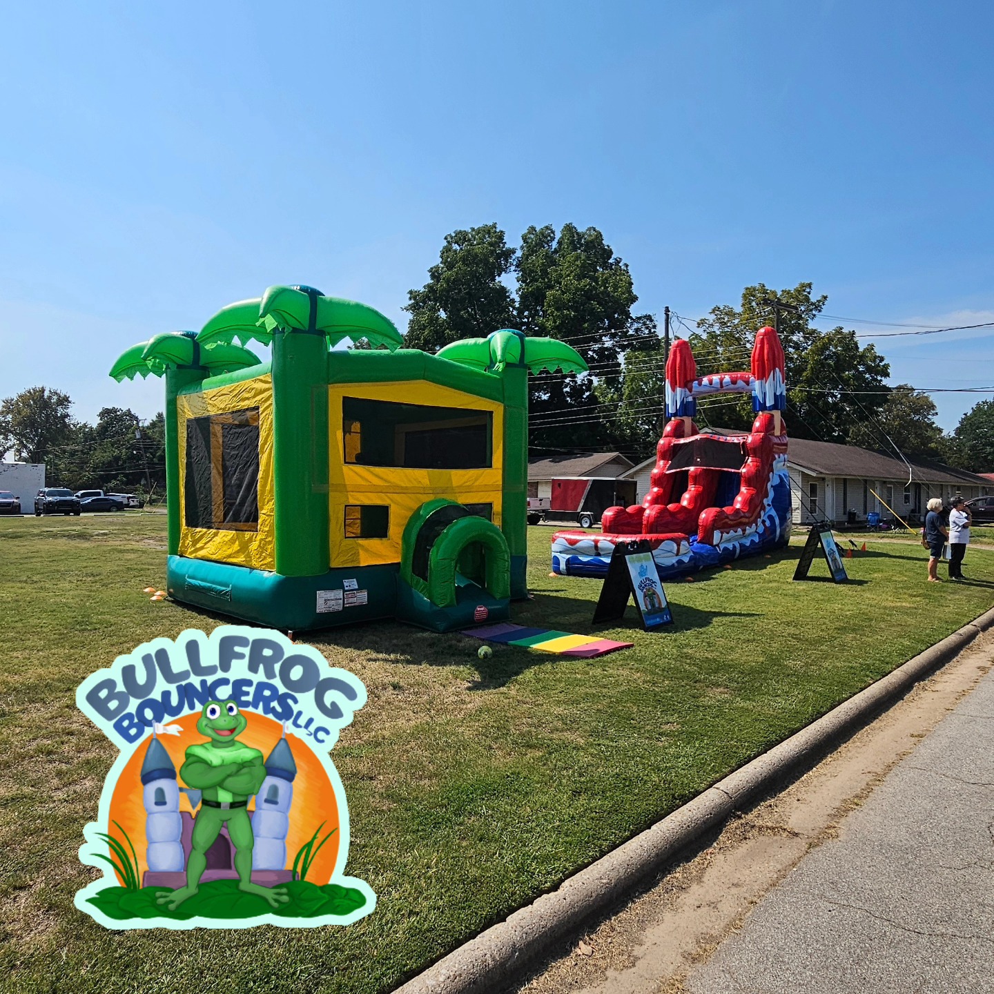 Palm tree bounce house and water slide combo at neighborhood event