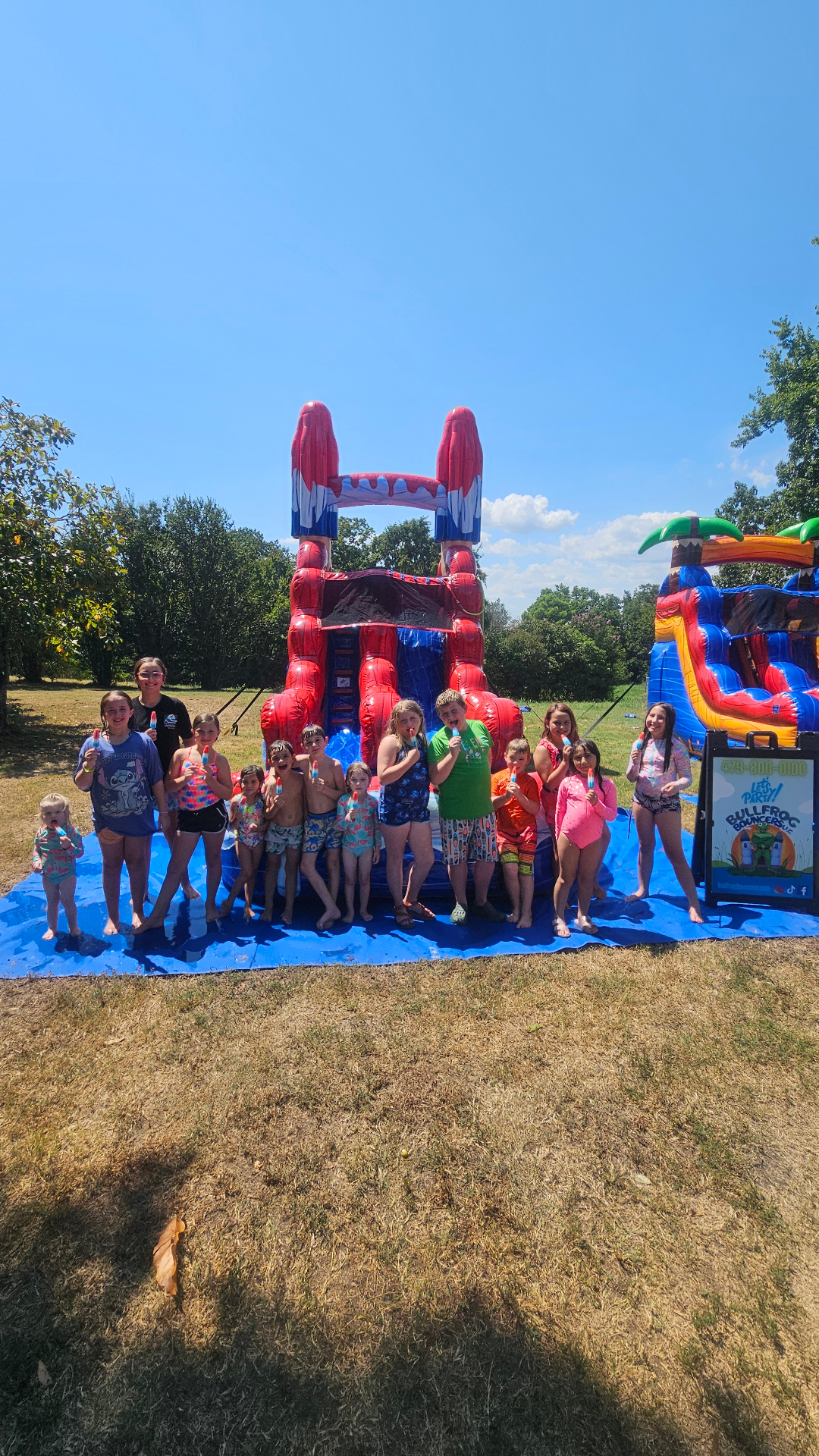 Kids enjoying water slide rental at summer party in Fort Smith